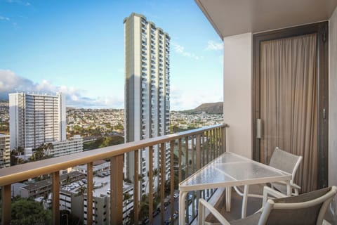 Private balcony with seating and striking views of Diamond Head, the cityscape, and surrounding mountains—your perch for morning coffee or evening relaxation.