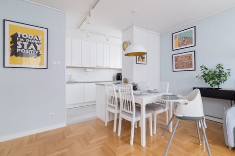 Another perspective of the open-plan dining and living area, emphasizing brightness and elegance.

