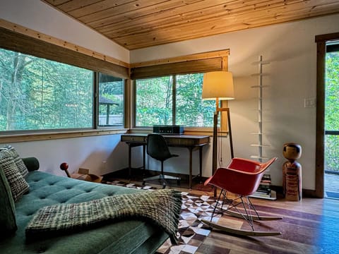 A peaceful workspace with a view—ideal for journaling, remote work, or curling up with a good book.