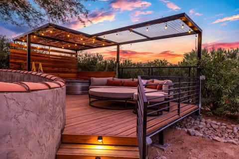 Enjoy a cozy evening on the cushioned deck at the casita yard!