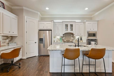 Warmly lit island with stools perfect for sharing quiet mornings.