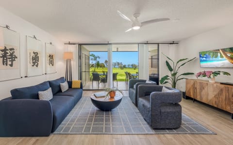 Unwind in your stylish living space with plush seating, modern décor, and stunning golf course views through expansive glass doors.