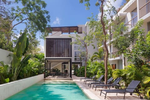 Spacious pool with hammocks—perfect spot to relax and unwind.