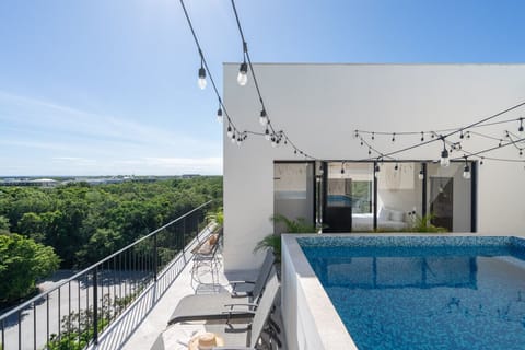 Private rooftop pool with stunning views—perfect for relaxing and sunbathing.
