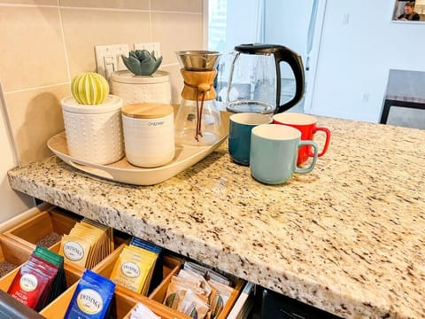 Guests can begin their mornings at the inviting coffee and tea station, thoughtfully stocked with a selection of Twinings teas, fresh brew options, and all the essentials for a cozy start. It’s the perfect touch of comfort to ease into your Vancouver day.