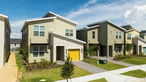 Welcome to your stylish home away from home! This modern 5-bedroom villa in Champions Gate offers a sleek exterior and stone accents, setting the stage for an unforgettable Florida vacation.