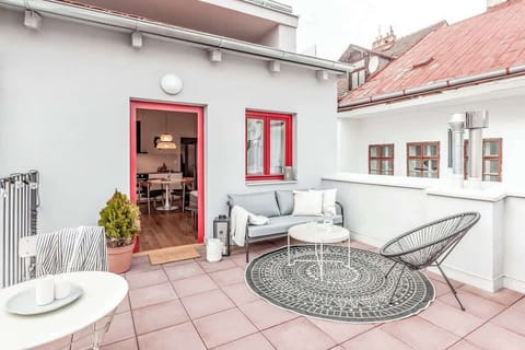 A large terrace facing a quiet backyard.