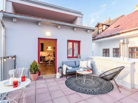 A large terrace facing a quiet backyard.