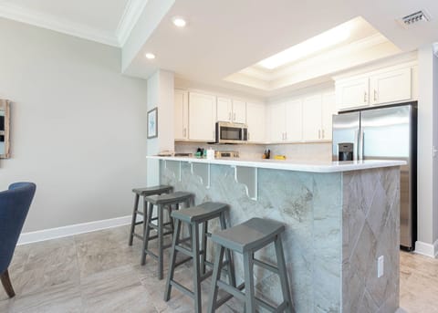 Savor your morning coffee in this inviting kitchen space with stainless appliances and stylish design