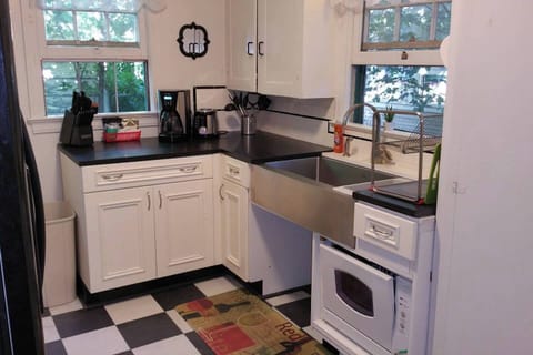 Honed Granite Countertops with $1100 Stainless Steel Farmsink in this updated kitchen. Open area underneath sink was designed as a pet feeding station. Pico Remote control at the back door runs the Welcome Home Scene, Relax Scene and All Off Scene. Never walk in the dark in this Townhome!    