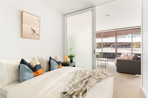 The master bedroom with a queen sized bed & plush pillows.