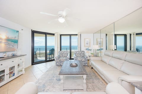 Unwind in plush seating as you watch the waves roll in, feeling the serene coast vibe embrace you