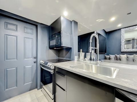 Entertain with big screens, a stone table for 12, and a fully-equipped kitchen