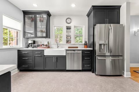 Custom cabinets and that farmhouse sink. GE Profile appliances through-out. 
