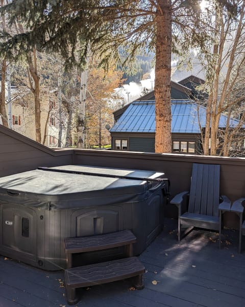 Upper outdoor deck with private hot tub and views.