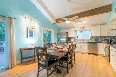 Step into the heart of the home where the kitchen flows seamlessly into the dining area, inviting shared meals and lively conversation.