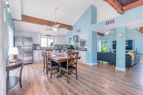 Feel the inviting flow as the kitchen and dining area blend seamlessly into the cozy living room, perfect for shared meals and relaxed conversations.