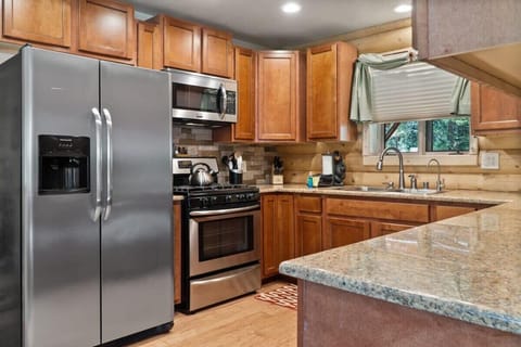 The kitchen boasts stainless steel appliances and a full range of basic cookware so you can prepare meals at home during your stay.