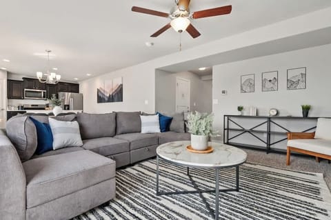 Cozy sectional sofa, 65" TV, base green accent wall