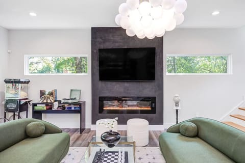 Cozy up on the stylish sofas next to the fireplace and watch TV on the 65` flat screen TV, listen to records make popcorn, eat gum balls, play board games, play your favorite music on the bluetooth speaker, or play a game of chess. Family heaven!