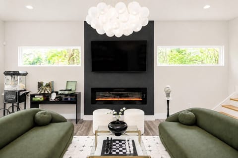 Cozy up on the stylish sofas next to the fireplace and watch TV on the 65` flat screen TV, listen to records make popcorn, eat gum balls, play board games, play your favorite music on the bluetooth speaker, or play a game of chess. Family heaven!