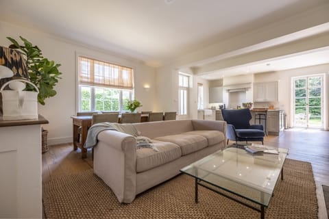 Kitchen, sitting and dining area with table seating eight guests