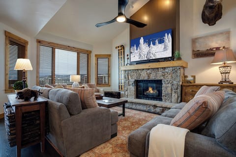 Cozy up by your stone fireplace with mountain views streaming through wood-framed windows.