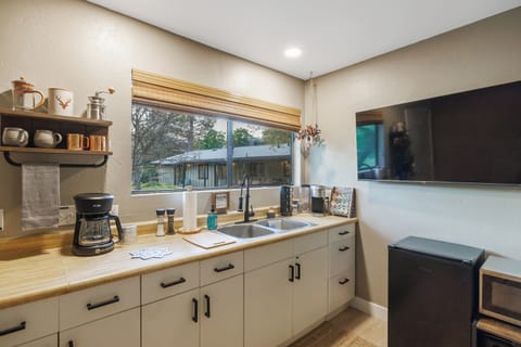 Kitchenette with fridge, micro, coffee station, large tv adjusts to face bed. 