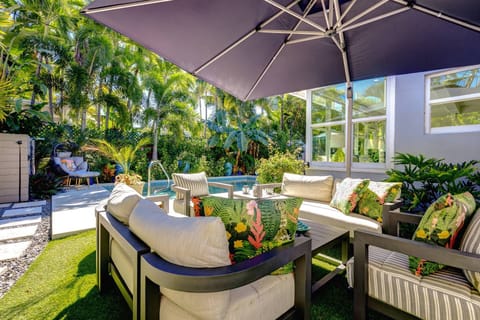 Relax beneath the umbrella with your favorite drink in hand, taking in peaceful pool views as the day drifts by.