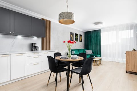 Elegant dining table setup with a contemporary light fixture, creating a sophisticated atmosphere.