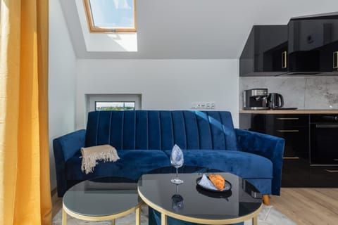 Comfortable seating area with a blue sofa, yellow curtains, and stylish decor.

