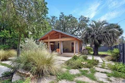 Front of Home Near Redfern Village - Exterior view with native palms, front porch, fenced yard, and a location 0.3 miles from Dulce Dough.