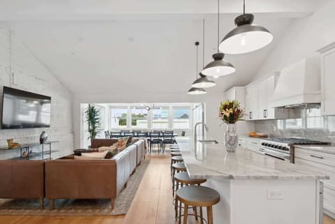 Welcome! Kitchen and Living Dining Area | Open Concept Layout with Large Seating Island for Eight Guests