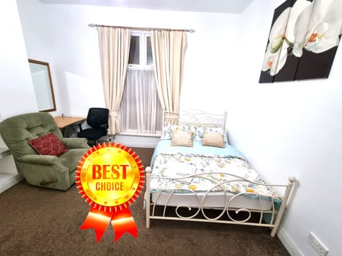 Cozy Retreat: Spacious double & single beds, work desk, and sofa armchair. 