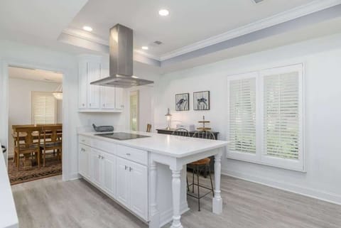 Large glass French doors flood the room with natural light.

