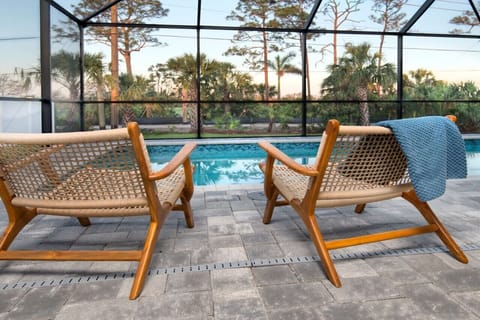 Outdoor Oasis: Enjoy sun-soaked days by the pool from stylish lounge chairs in paradise!