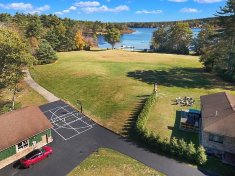 View of Highland Lake over the Lakehouse and rec center with hot tub, Tesla charger, outdoor basketball and pickle ball courts, and indoor ping pong, pop-a-shot, foosball, corn hole,  darts, TV, and more.