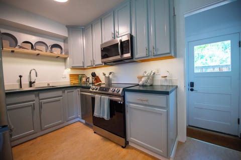 Full kitchen with drip coffee maker and brand new stainless steel appliances.