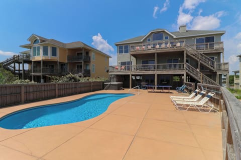 Back exterior and private pool and hot tub - Enjoy this private 15 by 34 heated pool and hot tub. Ping pong table is not included.