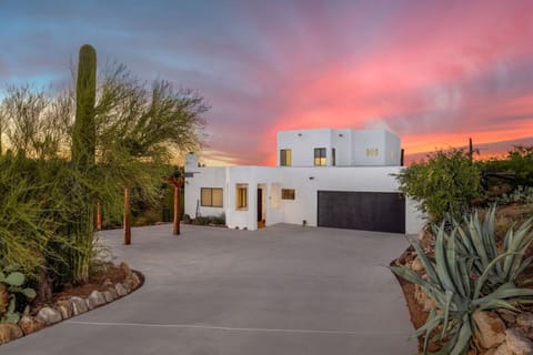 Secluded 2-story Southwestern-style property with 3 bedrooms and 2 bathrooms, lots of living and outdoor space, and plenty of parking with a 2-car garage and 3-car covered parking on the left