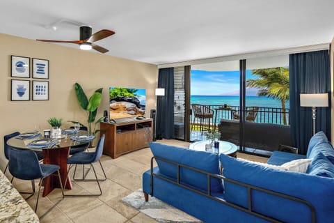 Bright, modern living room opens to stunning oceanfront lanai