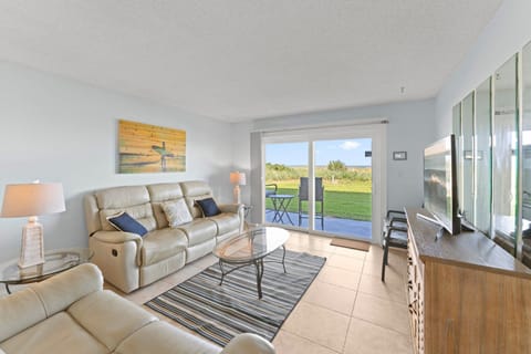 Relaxing living room with ground floor walkout and ocean view.