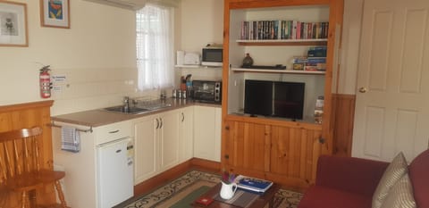 Cottage, 1 Bedroom, Kitchenette (The Retreat) | Living area | Flat-screen TV, DVD player