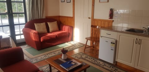 Cottage, 1 Bedroom, Kitchenette (The Retreat) | Living area | Flat-screen TV, DVD player