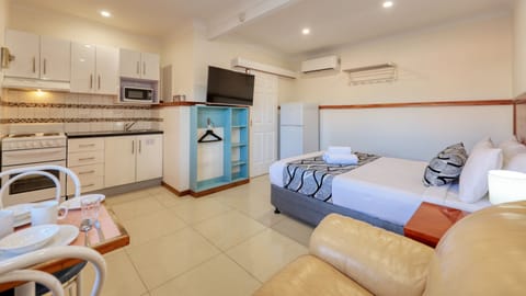 Executive One Bedroom Apartment | Premium bedding, desk, laptop workspace, iron/ironing board