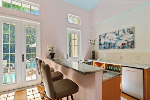 The downstairs bar features a mini fridge, sink, and bar items!