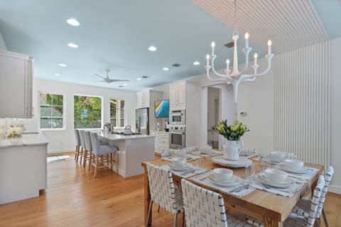 Beautiful white accents showcase this stunning kitchen and dining area with top of the line appliances.