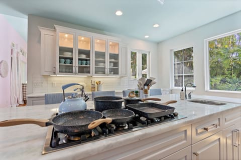 The kitchen is filled with cooking & baking utensils, dish-ware, and appliances like: waffle makers, blenders, hand mixers, etc.