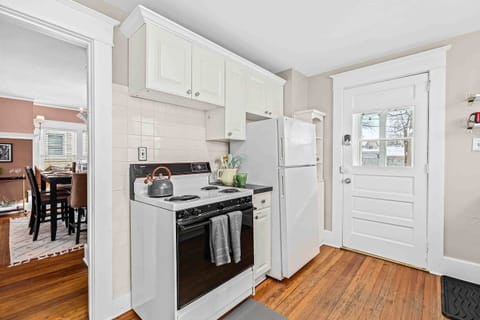 Kitchen includes fridge & stove as well as entry into the home