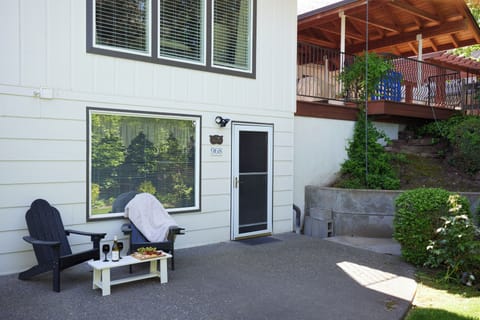 Start summer mornings with coffee on the serene back patio — guests call the afternoons here “very serene.” Adirondack chairs and a leafy garden make it your quiet retreat.